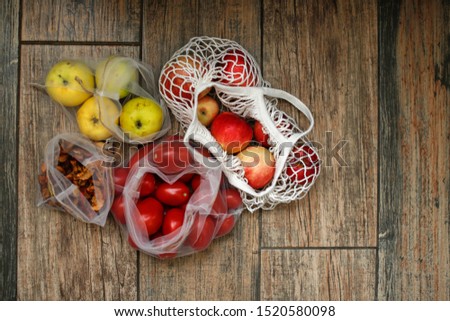 vegetables and fruits in mesh bags and string bag on a brown background, concept of zero waste, rejection of plastic bags. Eco-friendly lifestyle, storage