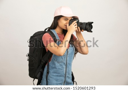 Pretty young professional photographer on white.