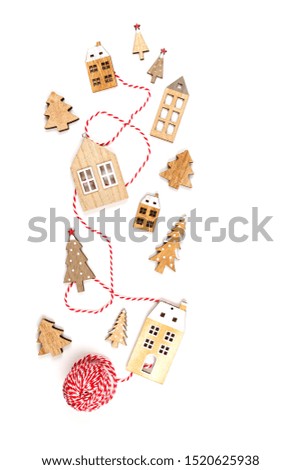 Christmas composition with   wooden decorations over the white background. Seasonal holidays, greeting card, invitation for xmas party concept. Flat lay. Top view