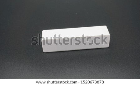 white portable battery to charge mobiles on black background