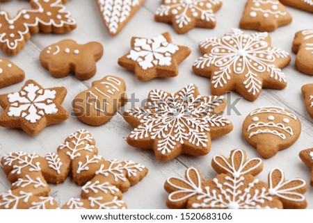 Christmas gingerbread cookies on white wooden background, close up view