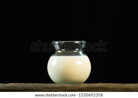 milk in glass on wooden isolate on black back ground,healthcare concept