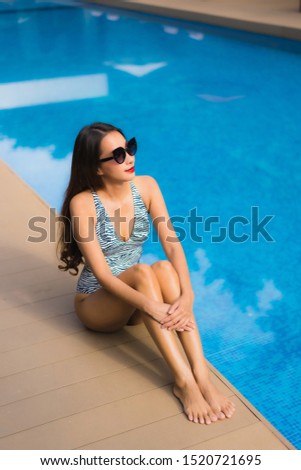 Beautiful portrait asian woman relax happy smile around outdoor swimming pool in holiday vacation