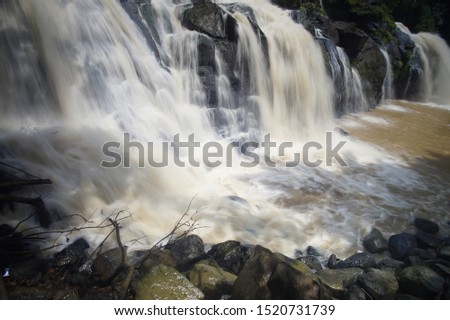 
waterfall with murky water after flood.