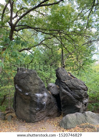 Two eccentric rock stones are in the picture. Right side stone look like a woman. 