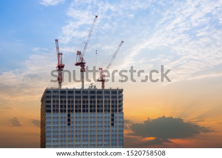 High rise building under construction in evening sky