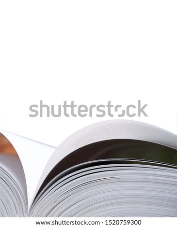 Opened book with curled pages and narrow depth of field isolated on white. Space for text above book