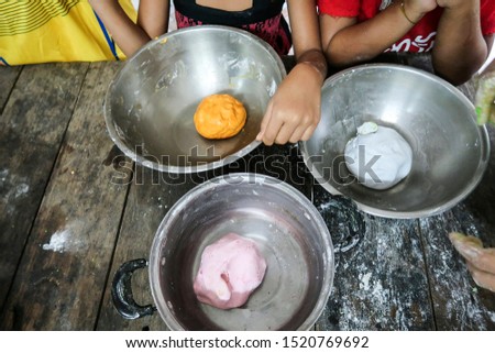 rice balls for Bua Loi or Thai style sticky dumpling in sweet coconut milk on rustic wooden table background, copy space. Children activity & Preparation concept   