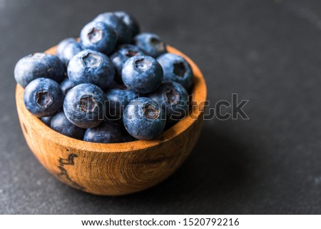 Close up of fresh organic blueberries on black background