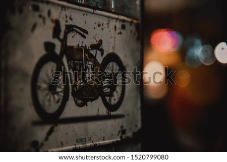 Picture of an old motorcycle framed with colorful bokeh