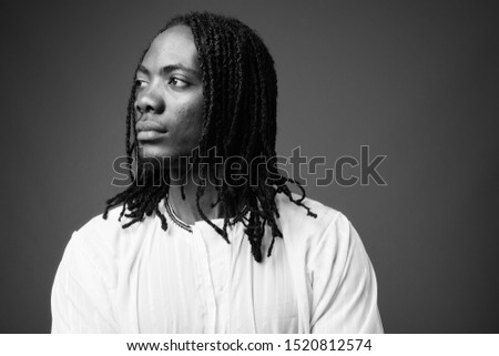 Young handsome African man wearing traditional clothes