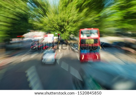 Blurred view of London traffic with rapid cars and buses movement.