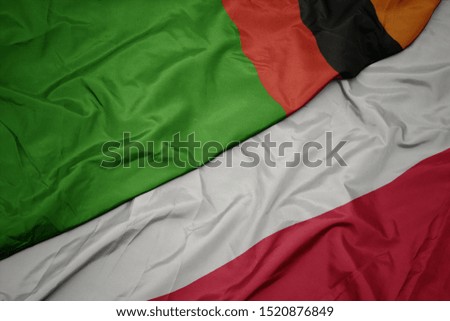 waving colorful flag of poland and national flag of zambia. macro