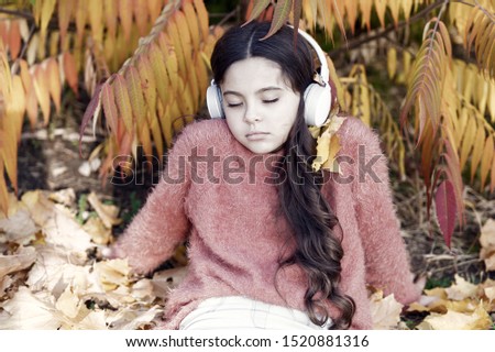 Melancholic melody. Listening song. Enjoy music outdoors fall warm day. Audio file. Boring podcast. Autumn playlist concept. Girl relaxing near autumn tree with headphones. Music for autumn cozy mood.