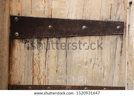 old iron door hinge on the background of old wooden door