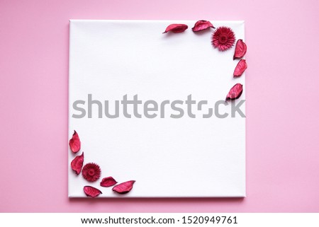 Flower composition. Frame made of autumn dried flowers and leaves on white canvas and pink background. Flat lay, top view, copy space.                