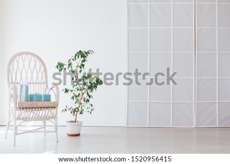 white vintage chair in the interior of an empty white room