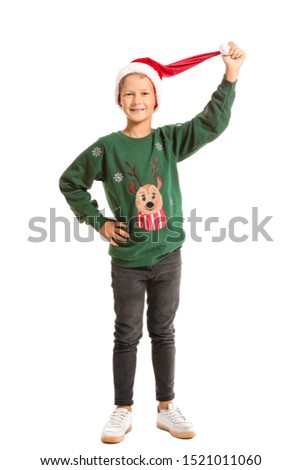 Little boy in Christmas sweater and Santa hat on white background