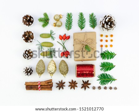Top view Christmas background or Christmas Card. Fur branches, pine cones and gifts pattern on white