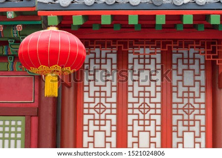 Red Chinese flashlight hanging on the house. Classical design concept in China.