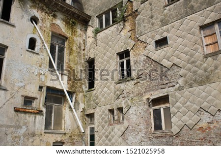 A low angle shot of an old building with wooden windows during daytime in Drogenbos, Belgium