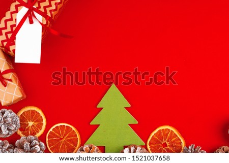 Christmas composition on red background with pine cones