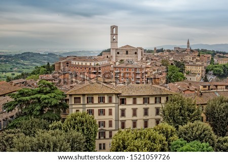 Perugia is a lively medieval walled hill town. View of the Basilica of San Domenico with medieval houses in Perugia historic quarter, Umbria, Italy