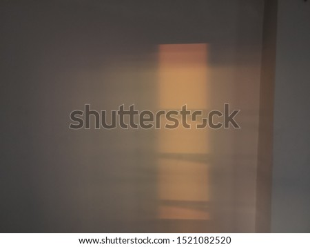 Sunlight through a window and shadows on the concrete wall