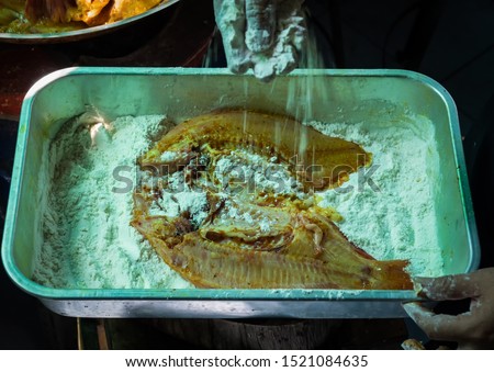 Cleaning-seasoning Tubtim fish for frying