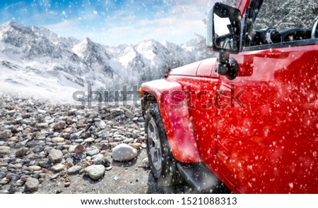 Red winter car and mountains landscape. Free space for your decoration 