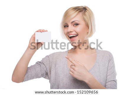 Woman with business card. Beautiful young blond hair woman holding business card and smiling while isolated on white