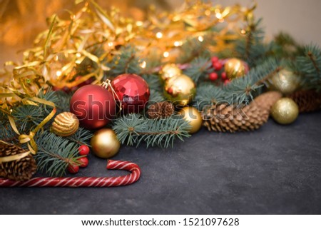 Christmas composition of gold and red balls, candy, garlands, fir branches, fir cones.  new year 2020