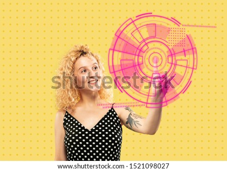 Modern technologies. Young caucasian woman's touching virtual reality in neon light on yellow background. Concept of human emotions, facial expression, modern gadgets and technologies. Copyspace.