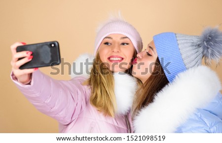 love you. happy winter holidays. Students friendship. girls in beanie. seasonal shopping. winter clothing fashion. down jacket. selfie time. women in padded warm coat. xmas vacation.