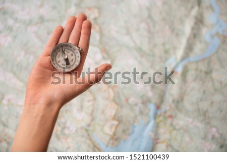 trekking map with hand, analog camera and compass for travellers, explorers or cientifics