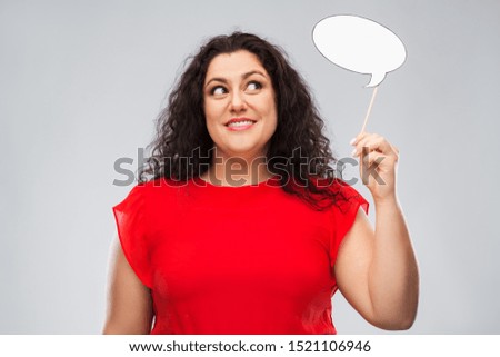 party props, photo booth and communication concept - happy woman in red dress holding big blank speech bubble over grey background Royalty-Free Stock Photo #1521106946