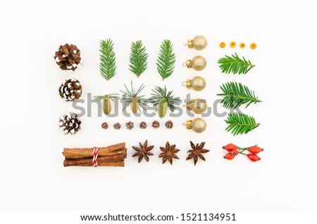 Flat lay aerial image of decorations and ornaments Merry Christmas and 2020 Happy New Year concept on white. Top view pattern made from cinnamon sticks, cones, Christmas toys, Christmas tree twigs