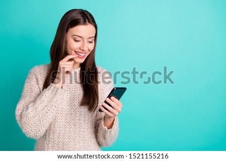 Turned photo of inspired lovely positive girl use her cellphone read post from feednews wear knitted pullover isolated over teal turquoise color background