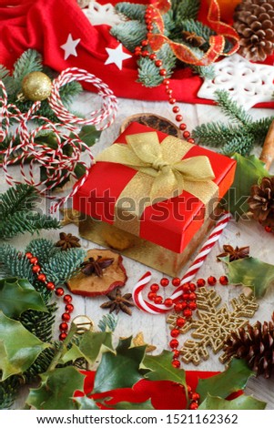 Red and golden Christmas decorations with fir branches and gift box