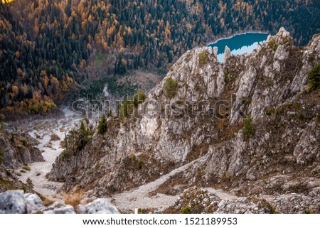 cliffs above alpine lake Malaya Ritsa in autumn