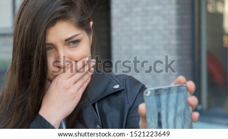 Crying woman showing broken screen smartphone, she sad