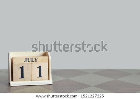 Empty Background with number cube on the table, July 11.