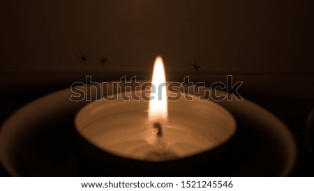 Beautiful picture of a candle with it's flame shining brightly.
