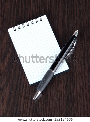 Notebook and pen on wooden table