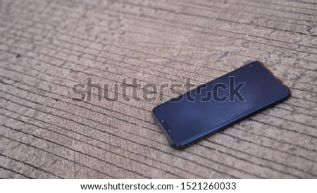 Blue smartphone On the cement floor     
