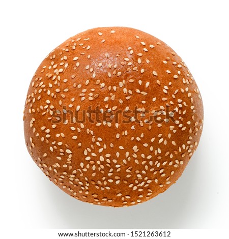 Sesame seed hamburger bun isolated on white. Top view. Royalty-Free Stock Photo #1521263612