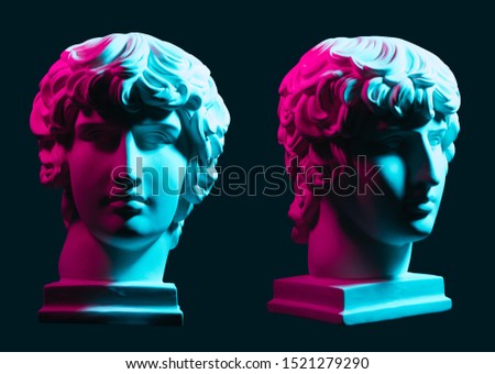 Statue neon. On a blue isolated background. Gypsum statue of Antinous head. Man.