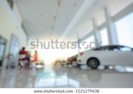 Blurred dealership store, with the cars and soft lightning., new car pictures in the showroom, show waiting for sales of branch dealers and new car service centers.
