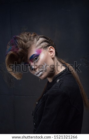 hairstyle for halloween. art make-up sugar skull, model shooting. A girl with black hellish eyes. Hairdressing. Hairstyle with colored sparkles. Beauty saloon. hairstyle contest