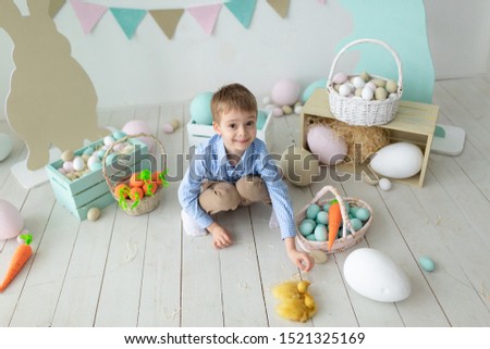 Cute little preschool child, boy, playing with easter eggs and chicks, easter happiness childhood concept
